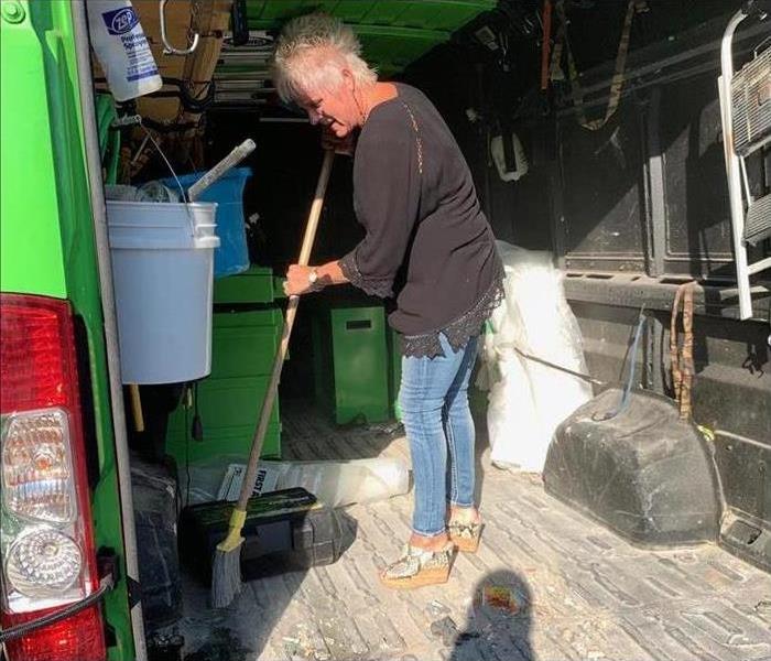 SERVPRO of Summit County / Lake Township Owner sweeping out dirty van