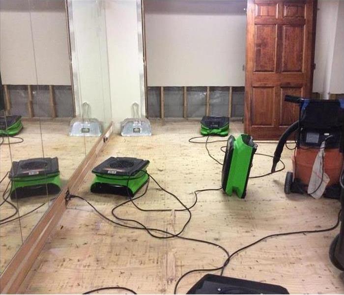 floor removed and wall cut in damaged game room near SERVPRO of Summit County / Lake Township
