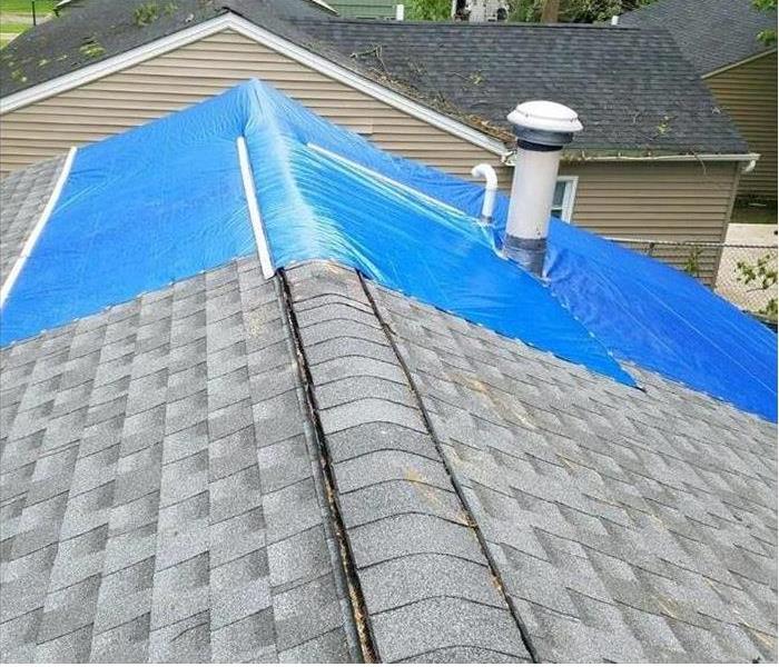Tarp on roof of house in Summit County / Lake Township